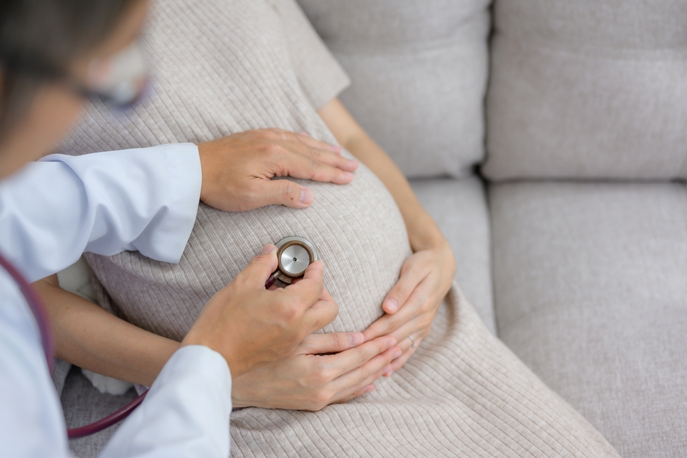 Obstetrician doctor doing health checkup for pregnant woman with large pregnancy and gynecology consultation Examine the stomach Health of pregnant women and prenatal care